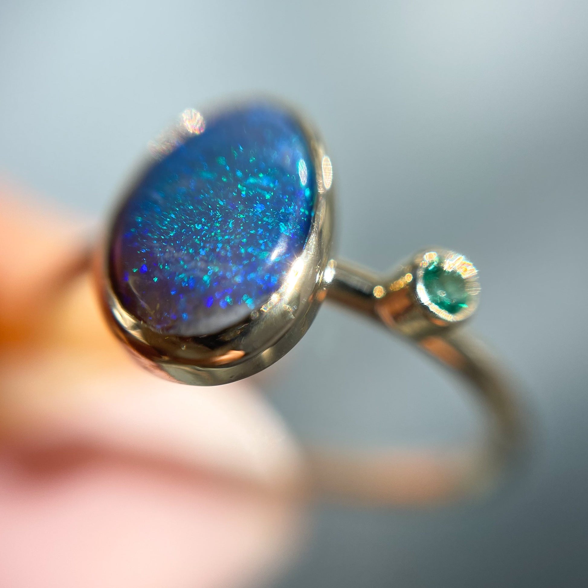 Magnified angled view of an Australian Opal Ring by NIXIN Jewelry. Shows the opal stone in a bezel setting.
