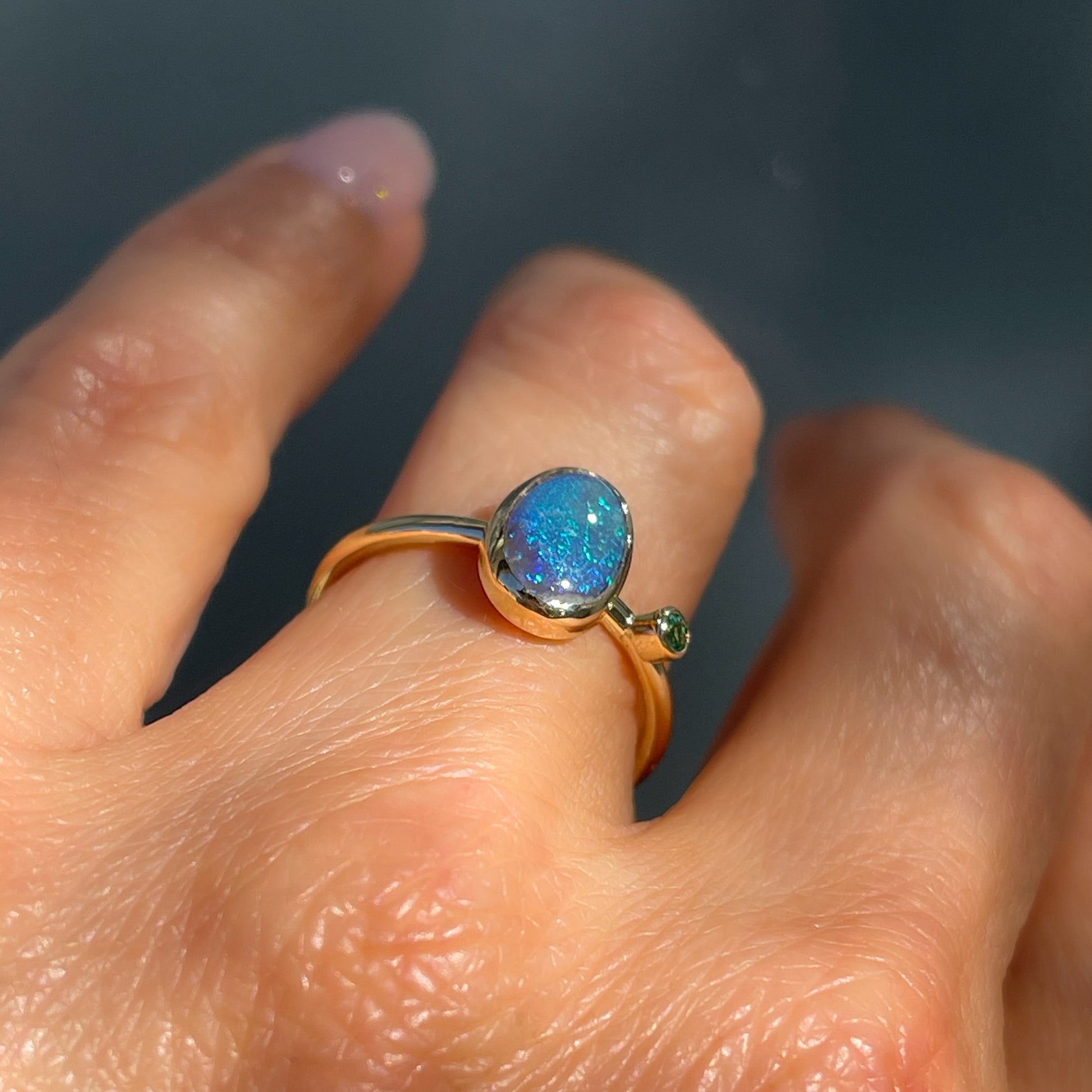 Angled view of an Australian Opal Ring by NIXIN Jewelry. A gold opal ring.
