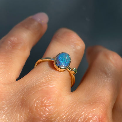 Angled view of an Australian Opal Ring by NIXIN Jewelry. A gold opal ring.