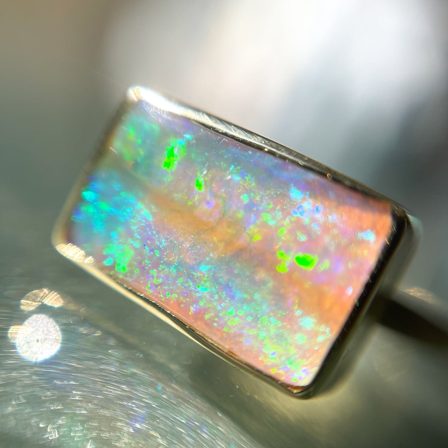 Close up of an Australian Opal Ring by NIXIN Jewelry with a Crystal Opal set in gold.