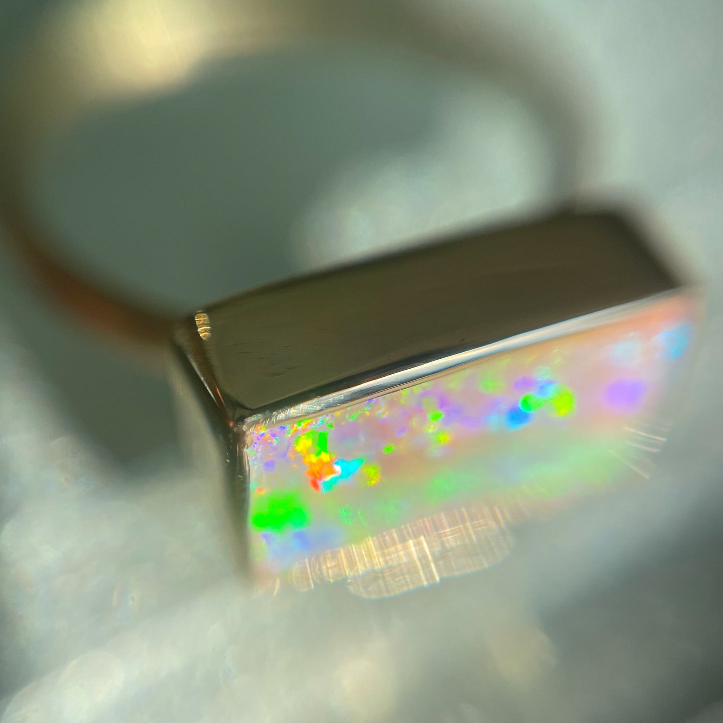 Top view of an Australian Opal Ring by NIXIN Jewelry showing the gold bezel setting of the opal ring.