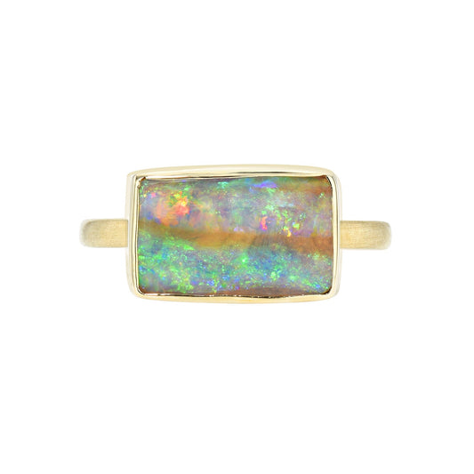 An Australian Opal Ring by NIXIN Jewelry made with a Pipe Opal in a gold bezel setting.