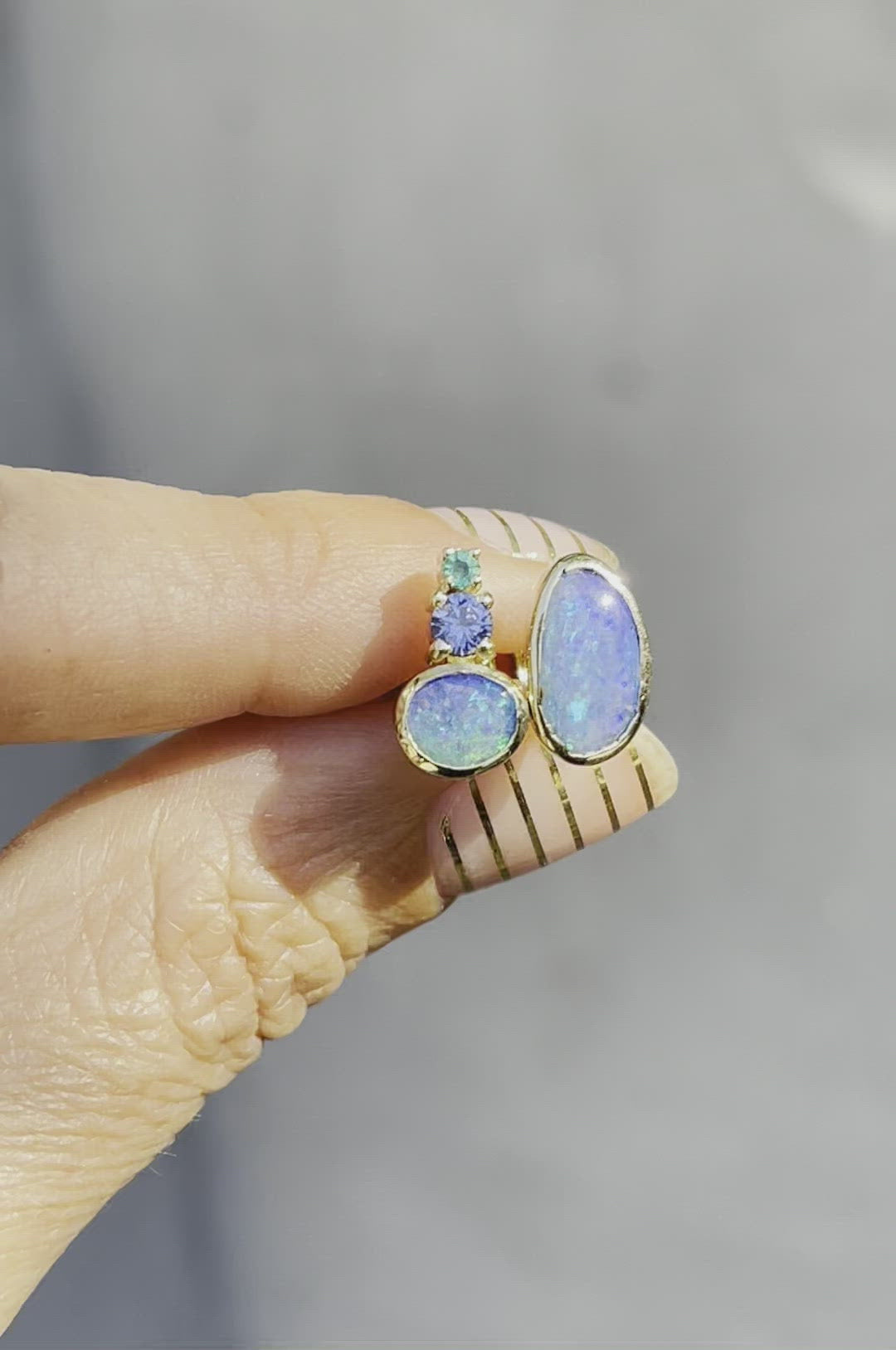 Video of blue opal stud earrings by NIXIN Jewelry moving in sunlight