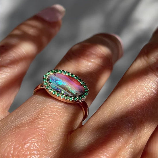 Video of Australian Opal and Emerald Ring by NIXIN Jewelry modeled on hand. Rose gold boulder opal ring.