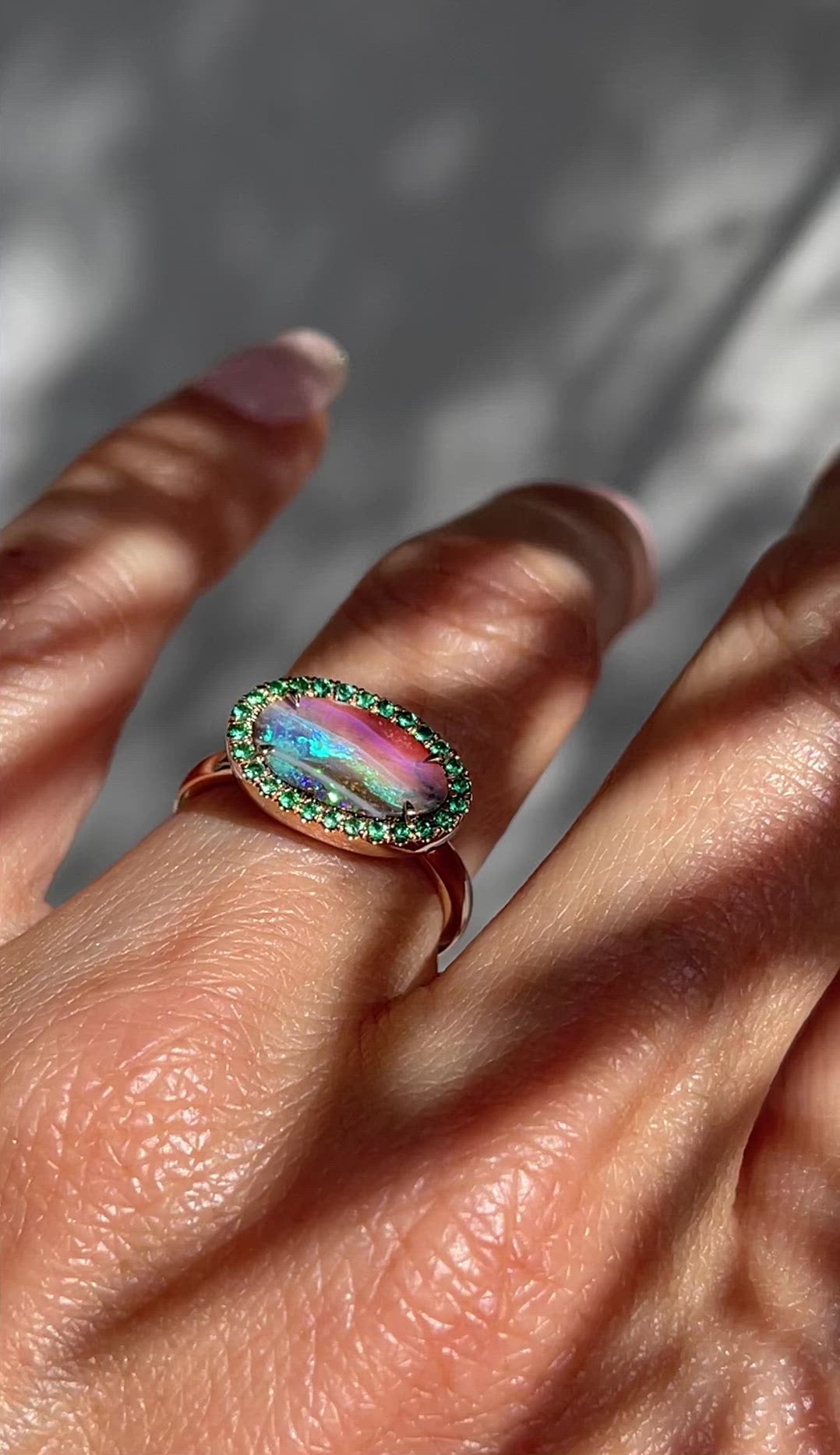 Video of Australian Opal and Emerald Ring by NIXIN Jewelry modeled on hand. Rose gold boulder opal ring.