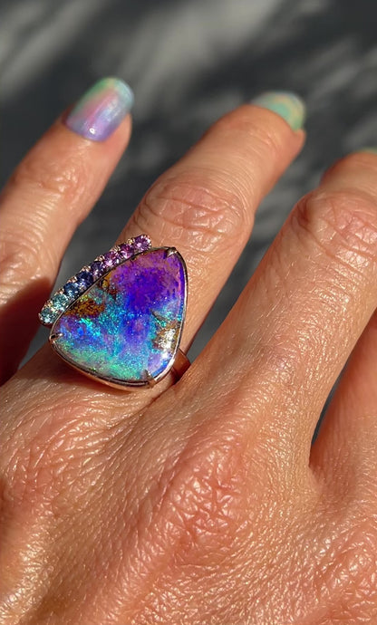 Video of an Australian Opal Ring by NIXIN Jewelry made with a Pipe Opal and Sapphires , on the model's hand.