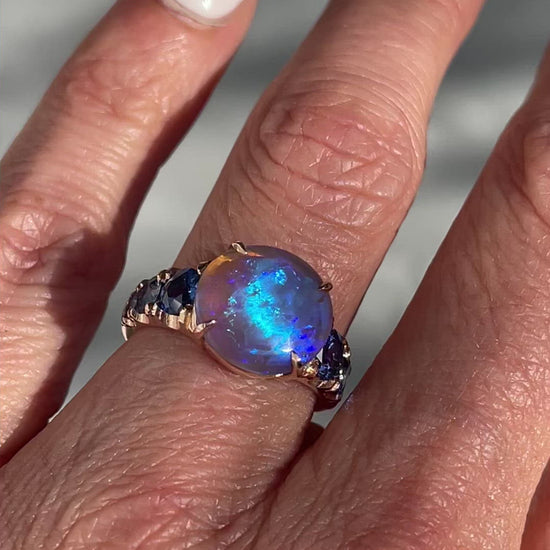 Video of black opal ring in 14k rose gold by NIXIN Jewelry on model's hand