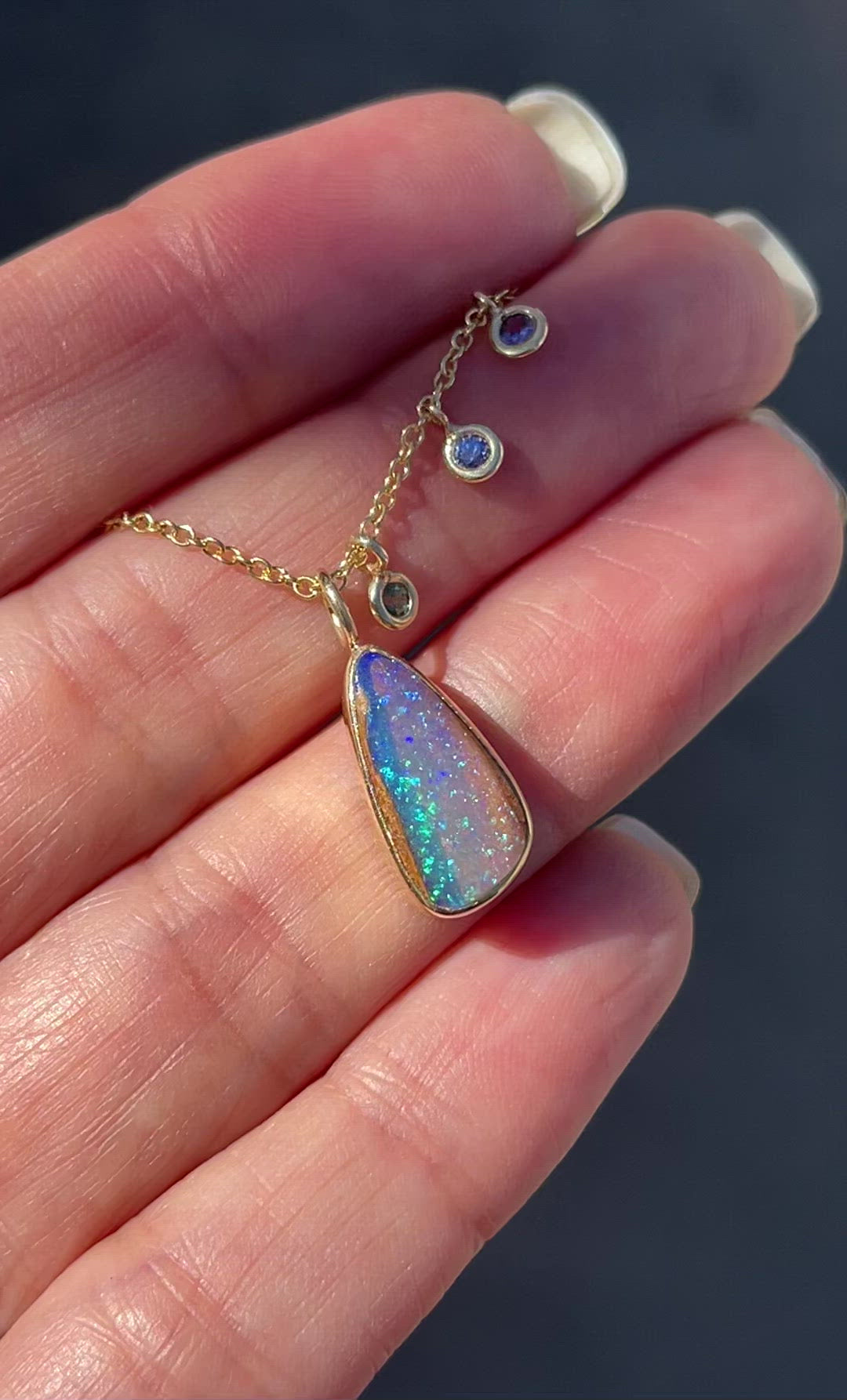 Video of sapphire and opal necklace by NIXIN Jewelry in sunlight