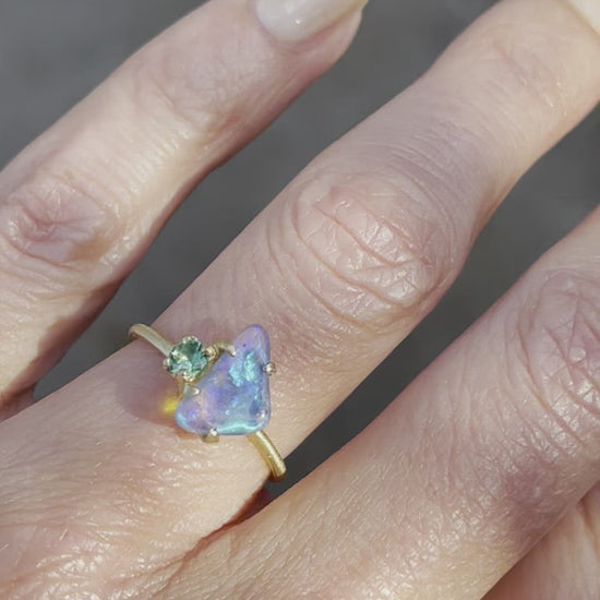 Video of blue and green opal ring with emerald by NIXIN Jewelry on hand