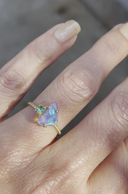Video of blue and green opal ring with emerald by NIXIN Jewelry on hand