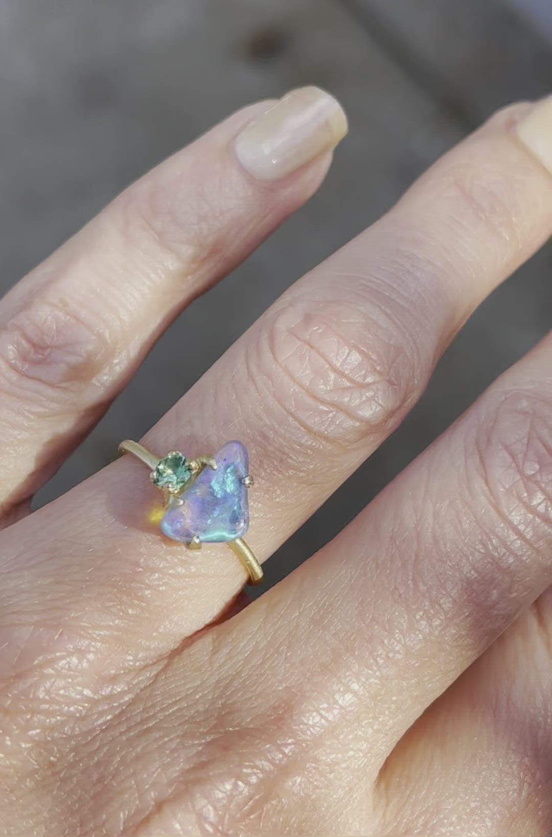 Video of blue and green opal ring with emerald by NIXIN Jewelry on hand