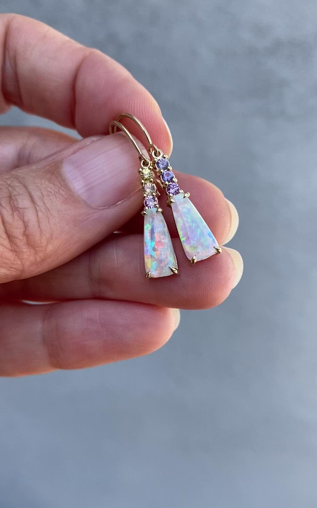 Video of gold opal earrings by NIXIN Jewelry in shade and sunlight