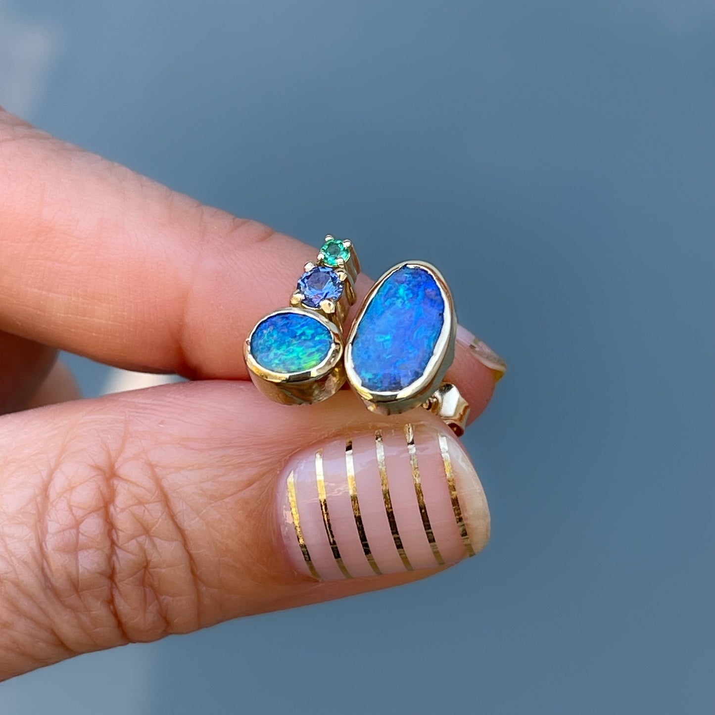Side view of asymmetrical boulder opal earrings by NIXIN Jewelry