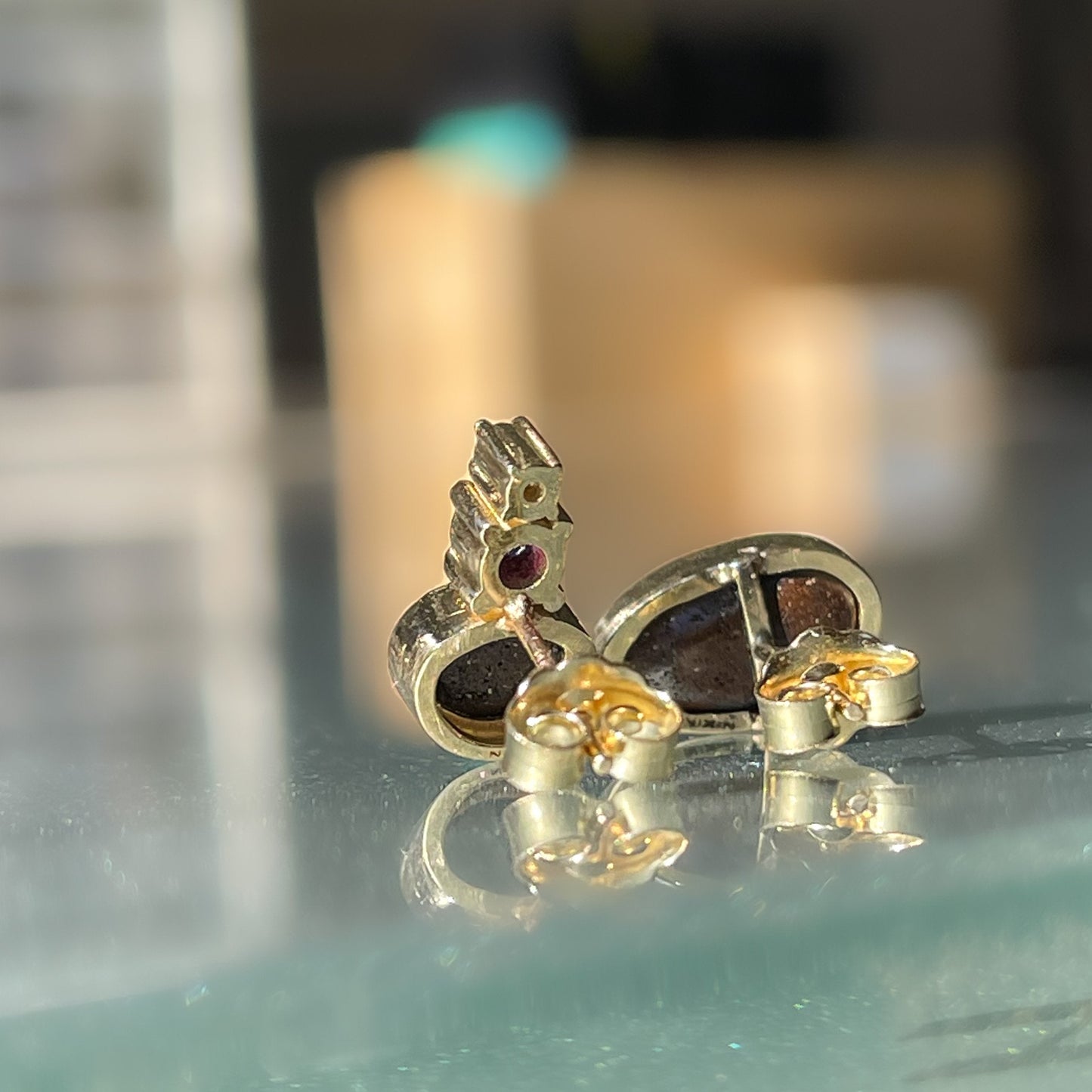 Back view of asymmetrical gold opal stud earrings by NIXIN Jewelry