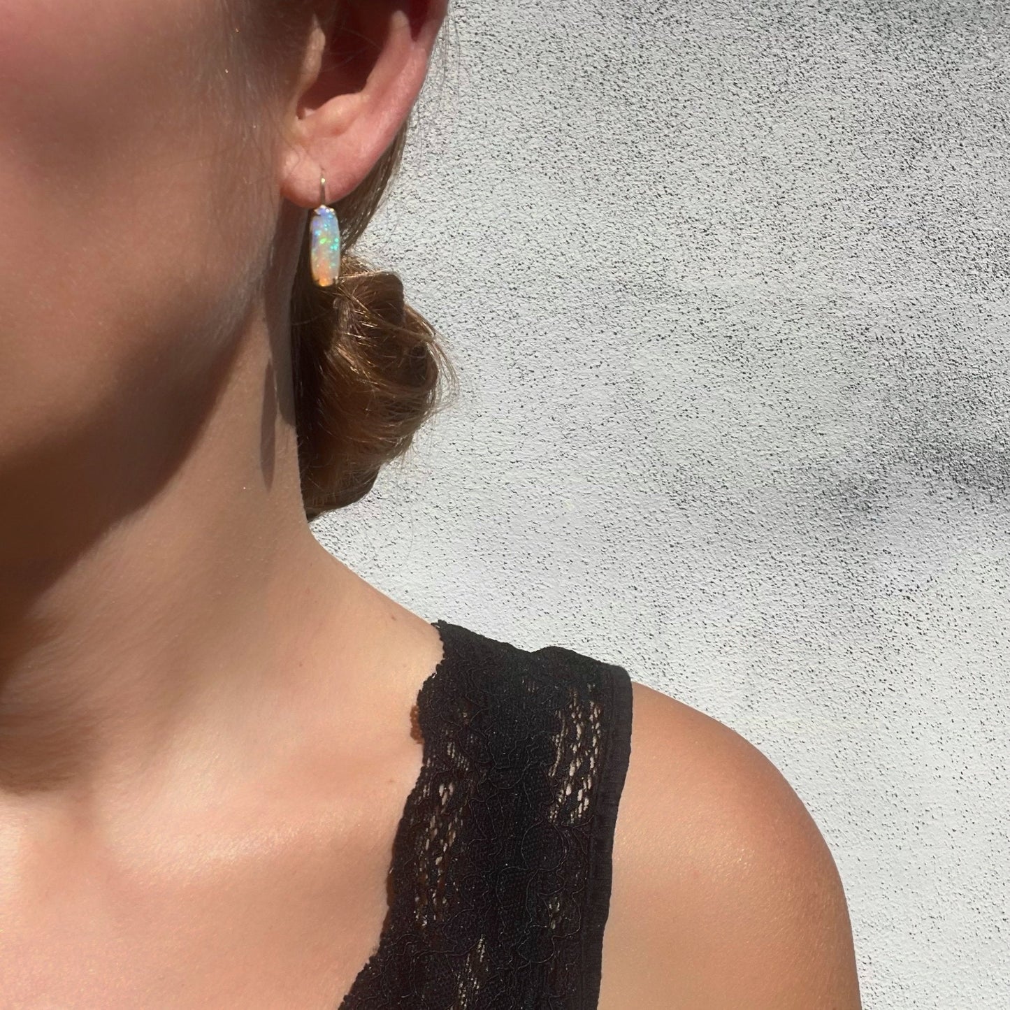 Model wearing Australian opal earrings by NIXIN Jewelry