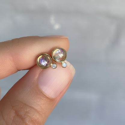 moonbeam moonstone diamond stud earrings in yellow gold in hand for scale