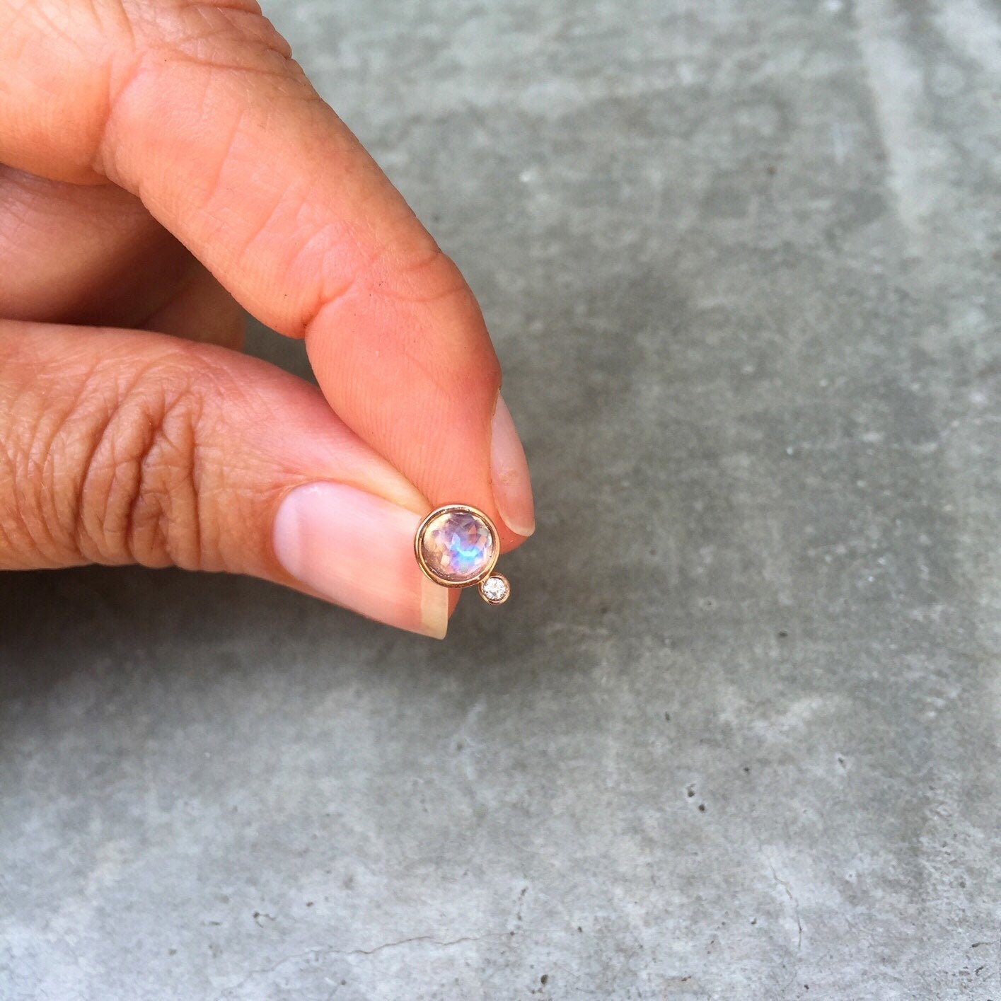 moonbeam moonstone diamond stud earrings in rose gold, scale next to hand