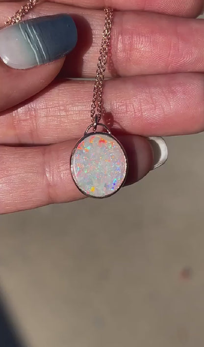 Video of an Australian Opal Necklace by NIXIN Jewelry shown in sunlight to display its rainbow colors.