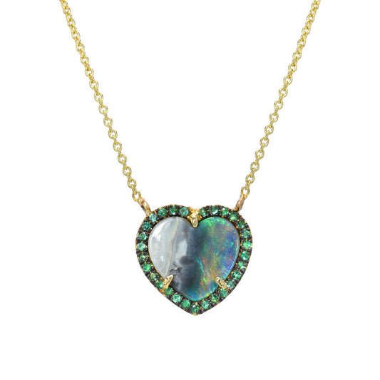 An Australian Opal Heart Necklace by NIXIN Jewelry in front of a white backdrop.