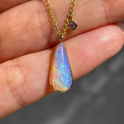 Australian Opal Necklace by NIXIN Jewelry resting on hand. Pipe opal necklace.
