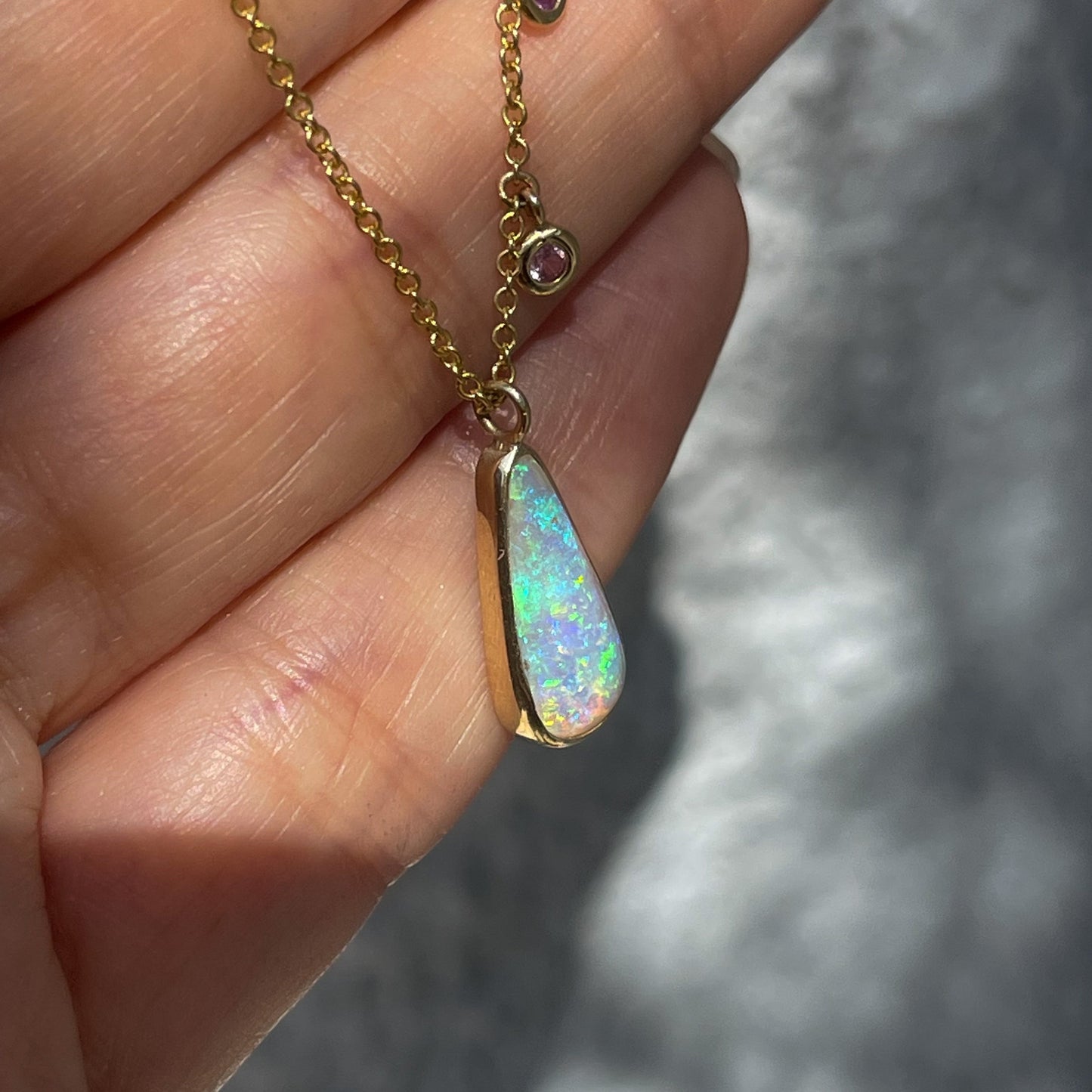 Australian Opal Necklace by NIXIN Jewelry shown at angle. Gold opal necklace.
