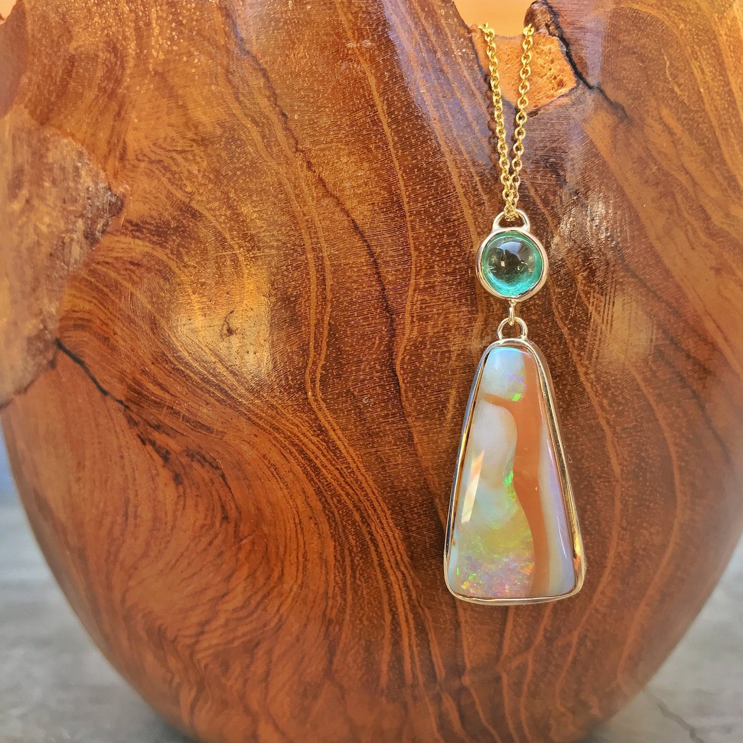 Fusion Muzo Colombian Emerald Opal Necklace on wooden bowl