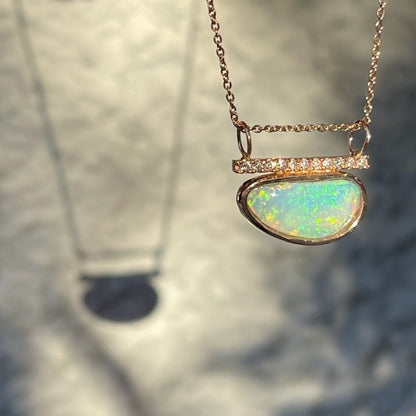 Rose gold Australian opal necklace by NIXIN Jewelry in sunlight