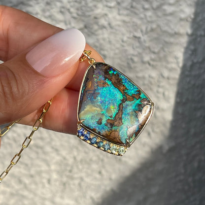 Large opal pendant with green opal by NIXIN Jewelry held in sunlight