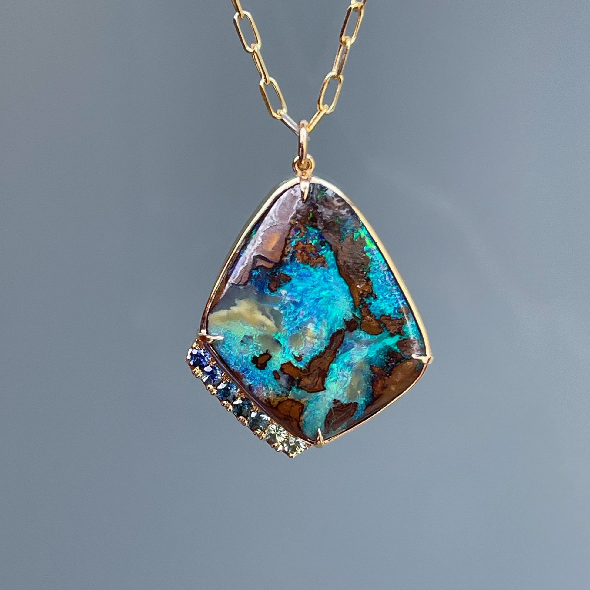 Opal and sapphire necklace on paperclip chain by NIXIN Jewelry against grey background