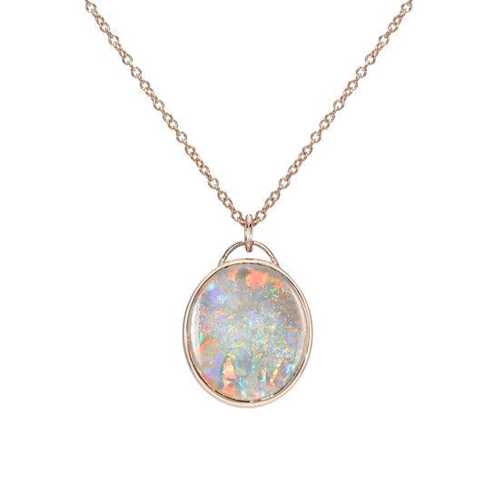 An Australian Opal Necklace by NIXIN Jewelry with a White Opal set in rose gold hangs in front of a white backdrop.