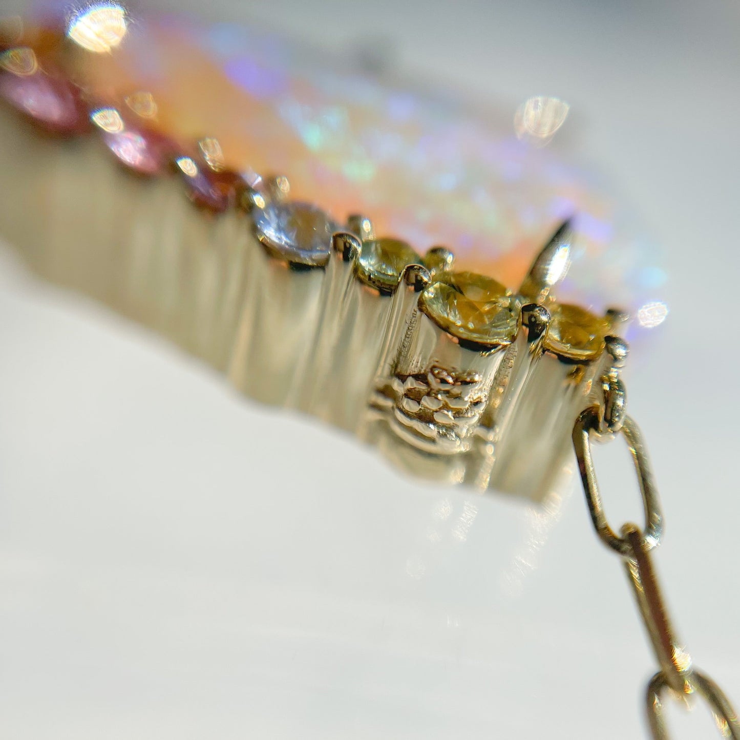 An Australian Opal Necklace by NIXIN Jewelry with a hidden detail on the back of the pendant. A close up shot of the gold opal necklace detail.