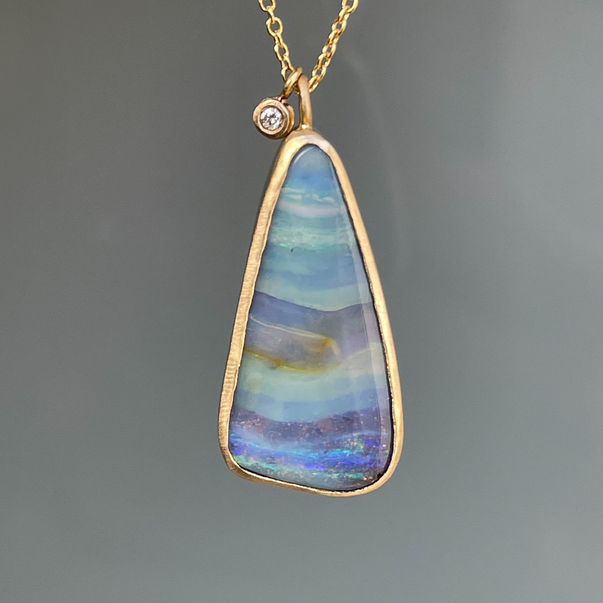 Opal pendant with boulder opal and matte gold by NIXIN Jewelry shown in shade