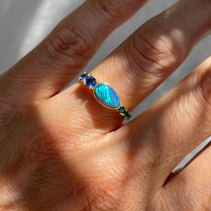 Black Opal Ring by NIXIN Jewelry modeled on hand. Blue and green opal ring.
