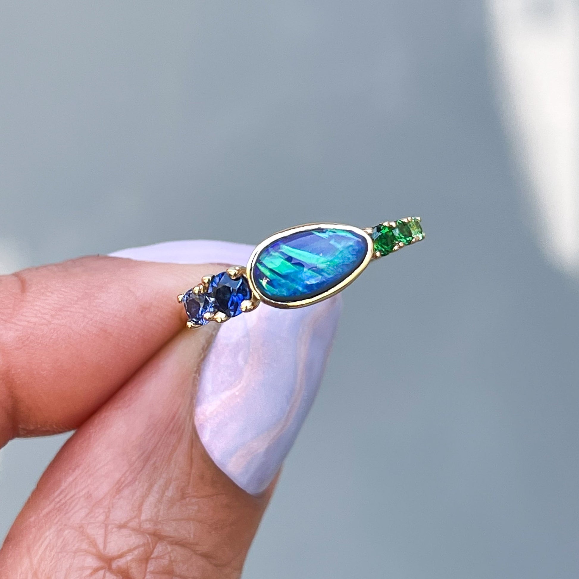 Black Opal Ring by NIXIN Jewelry held in shade. Real opal ring.