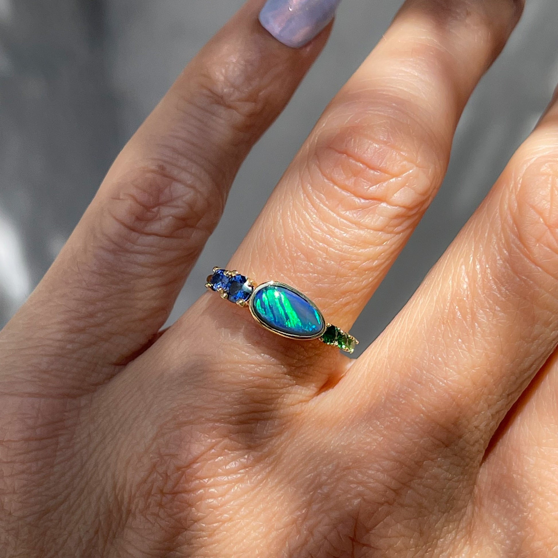 Black Opal Ring by NIXIN Jewelry modeled on hand. Australian opal ring.