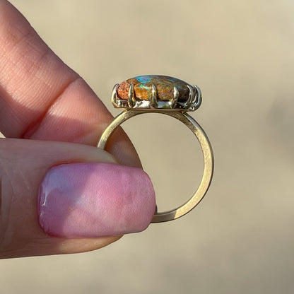 Profile view of a NIXIN Jewelry Australian Opal Ring gripping a wood fossil opal in a prong setting.