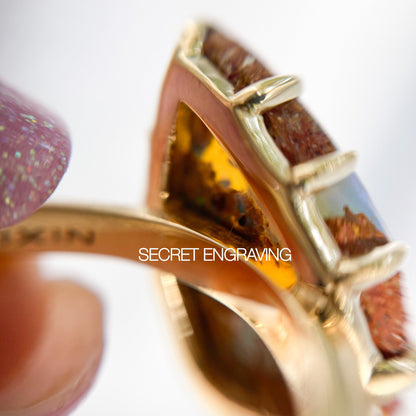 Magnified shot of a NIXIN Jewelry Australian Opal Ring showing the back of the Boulder Opal mounting and the location of the secret engraving.