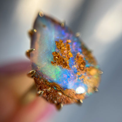 A NIXIN Jewelry Australian Opal Ring shot under magnification. A beautiful blue, green and purple opal ring.