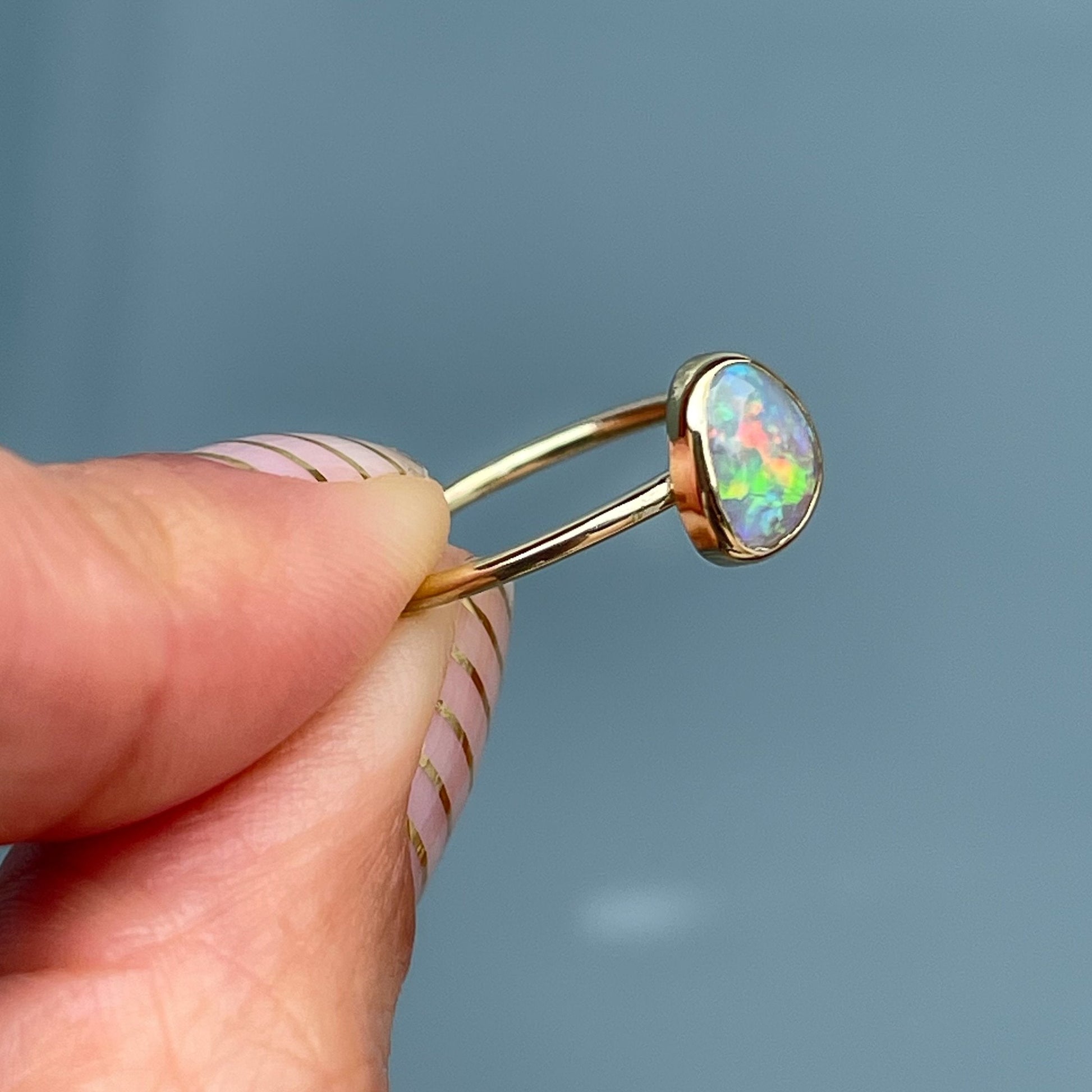 Side view of bezel set rainbow opal ring by NIXIN Jewelry