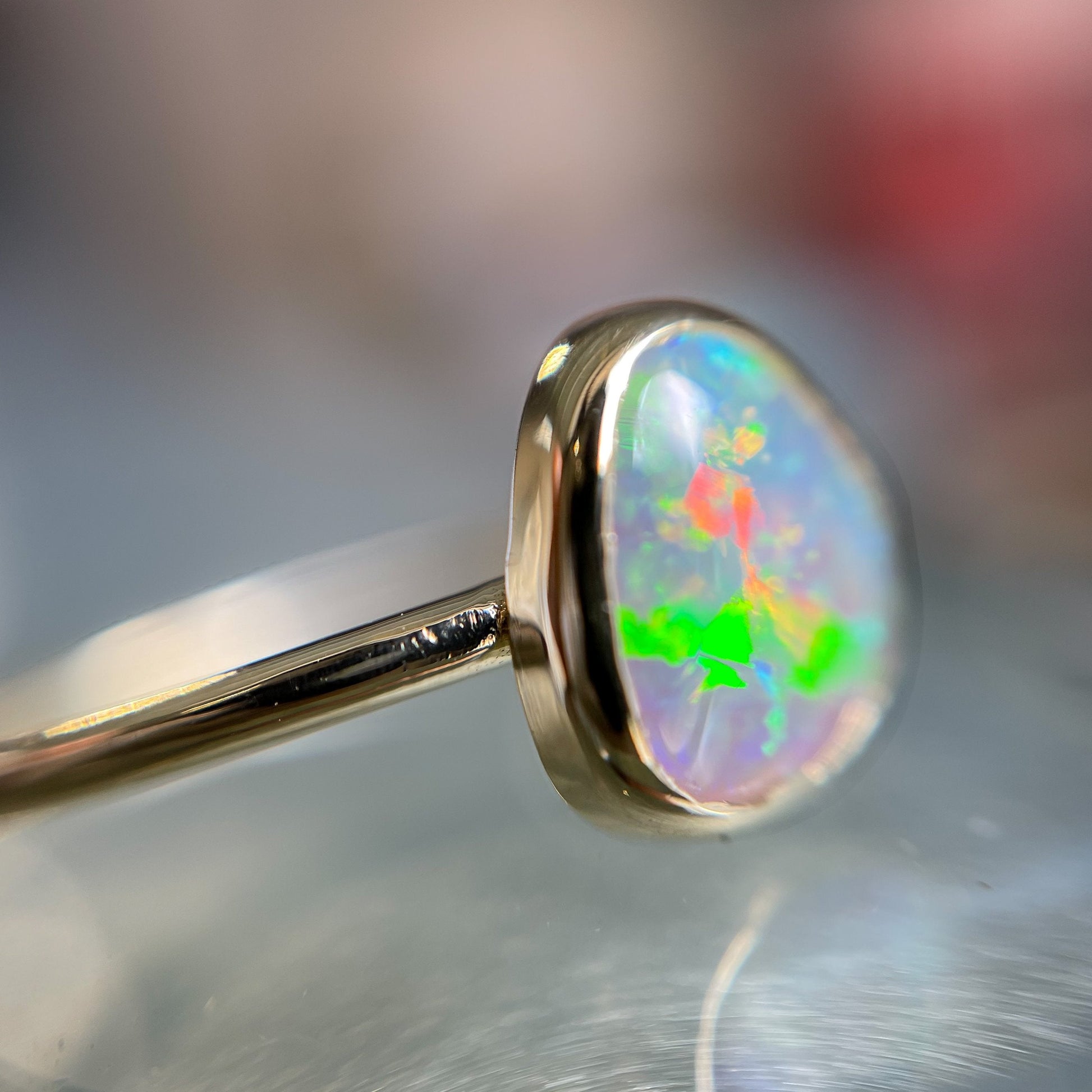 Close up of crystal opal ring with blue and green opal by NIXIN Jewelry