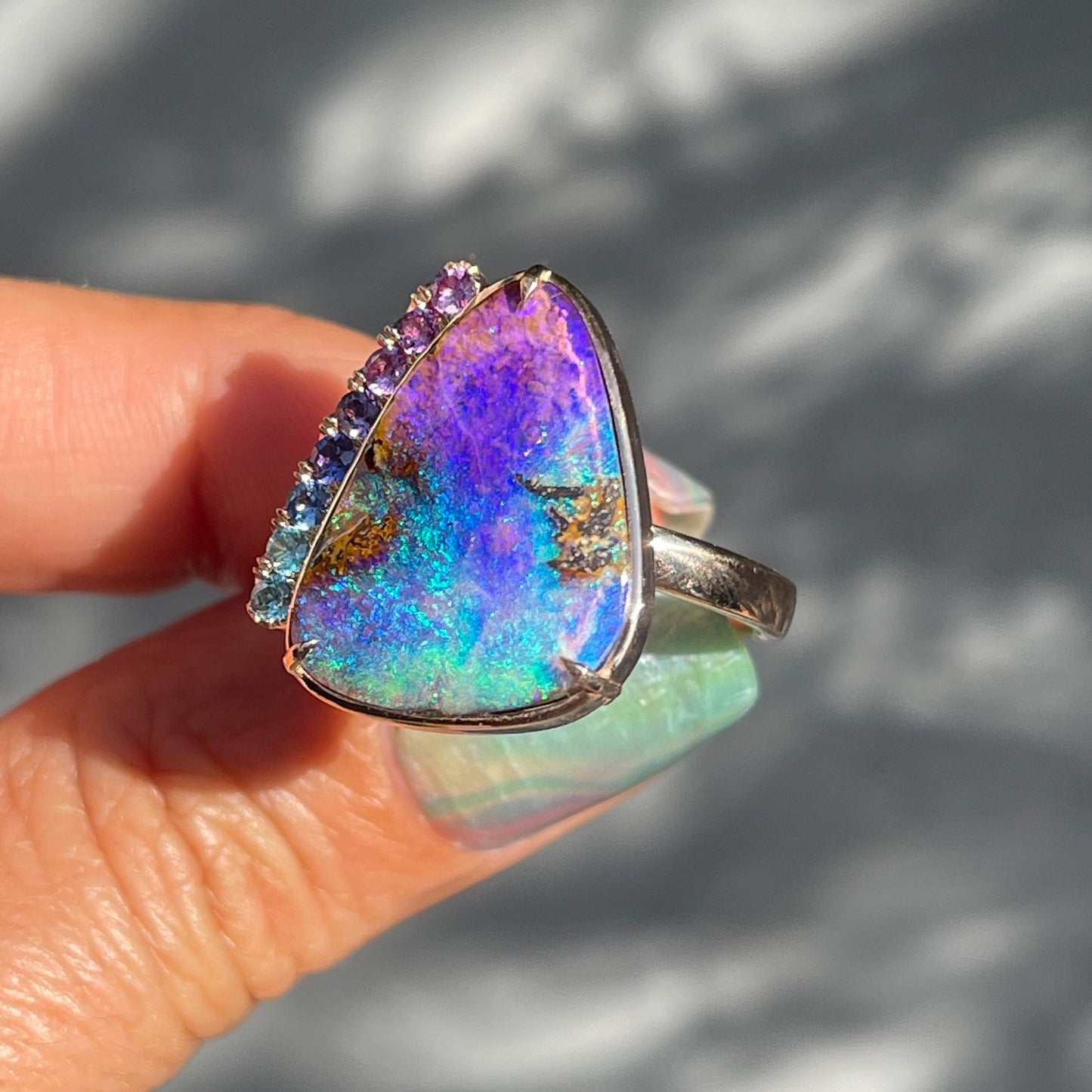 Angled photo of a purple and green Australian Opal Ring by NIXIN Jewelry.