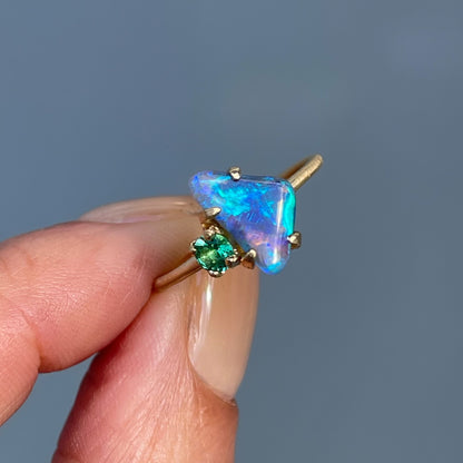Emerald and opal ring by NIXIN Jewelry held in shade