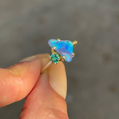 Australian opal ring with black crystal opal by NIXIN Jewelry held in sunlight