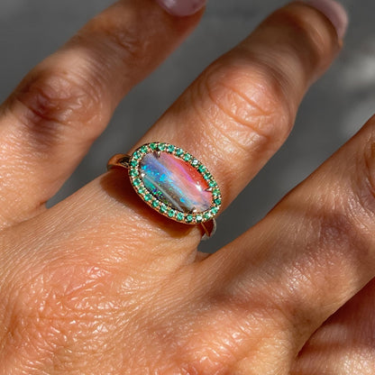 Australian Opal and Emerald Ring by NIXIN Jewelry modeled on hand. Australian opal ring.