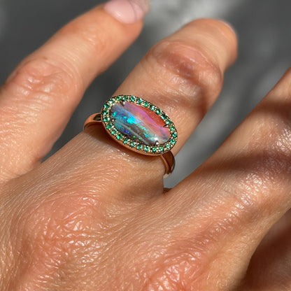 Australian Opal and Emerald Ring by NIXIN Jewelry shown on hand. Natural opal ring. 