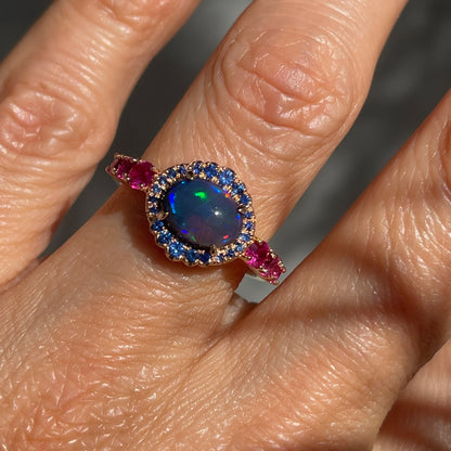 Sapphire and Opal Ring by NIXIN Jewelry modeled on hand. Natural Australian opal ring.