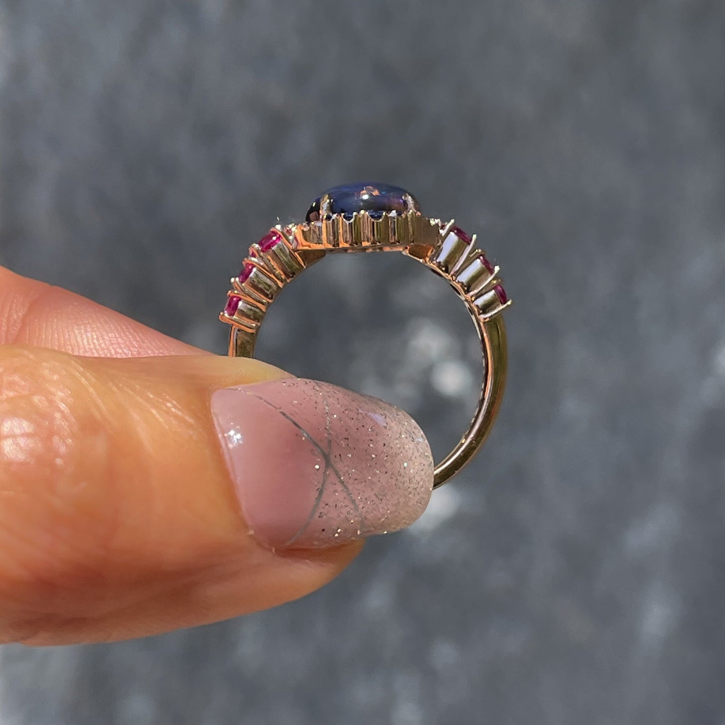 Sapphire and Opal Ring by NIXIN Jewelry showing side view. Rose gold Australian opal ring.