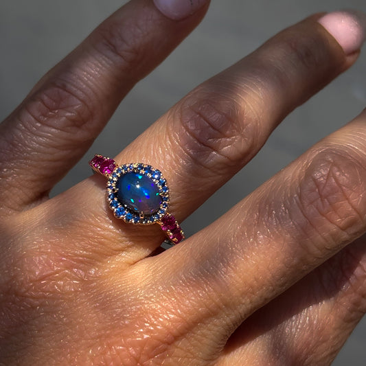 Sapphire and Opal Ring by NIXIN Jewelry modeled on hand. Sapphire and crystal opal ring.