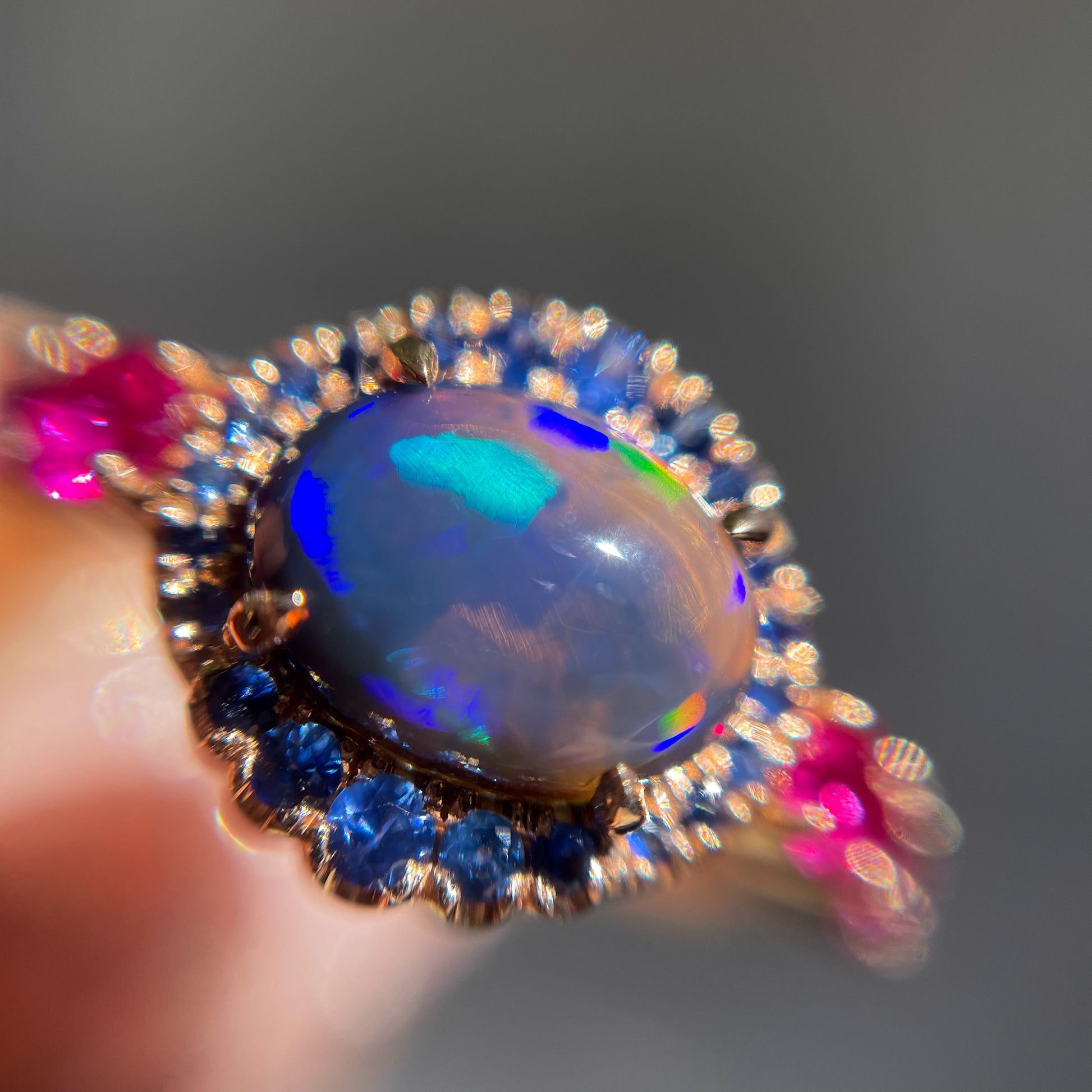 Sapphire and Opal Ring by NIXIN Jewelry shown magnified. Lightning Ridge opal and sapphire ring.