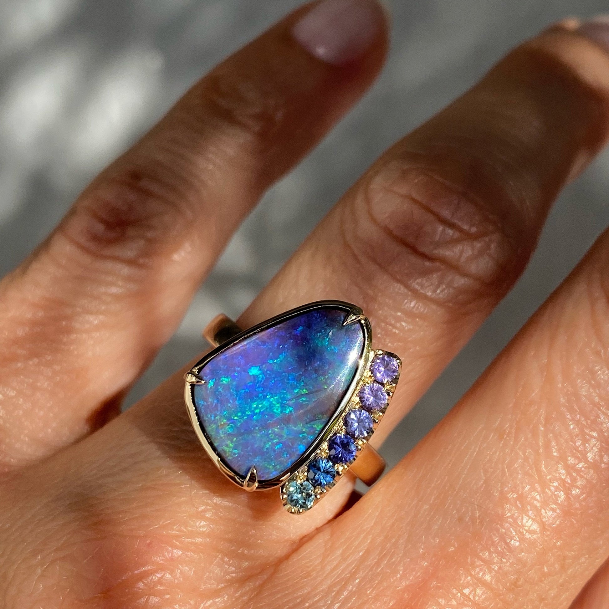 Opal sapphire ring by NIXIN Jewelry modeled on hand